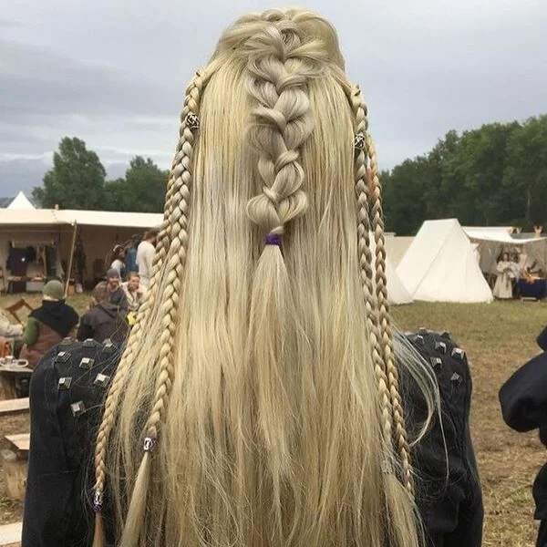 Loose Frette Viking Hairstyle - a woman wearing black viking attire