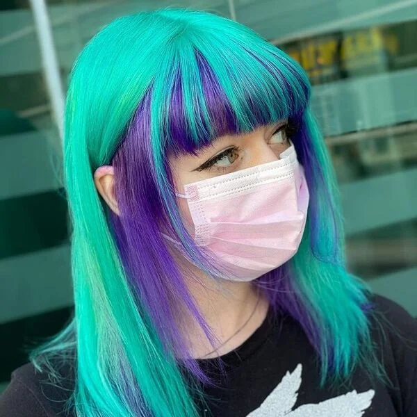Mint Green with Purple Peekaboo Hairstyle - a woman wearing black top with mask