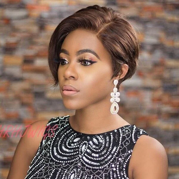 Medium brown side-parted pixie cut with sleek styling and eye-enhancing side puff - face-slimming short sassy haircut
