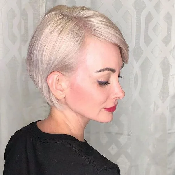 Bold and calm silver straight pixie cut with precise styling - statement-making short sassy haircut for cool or rosy undertones