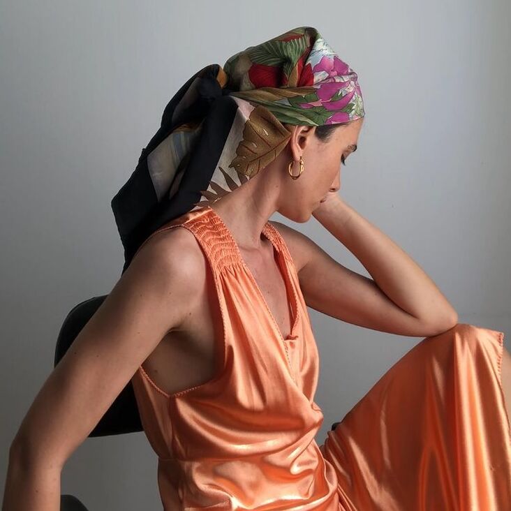 A woman wearing orange long silk dress