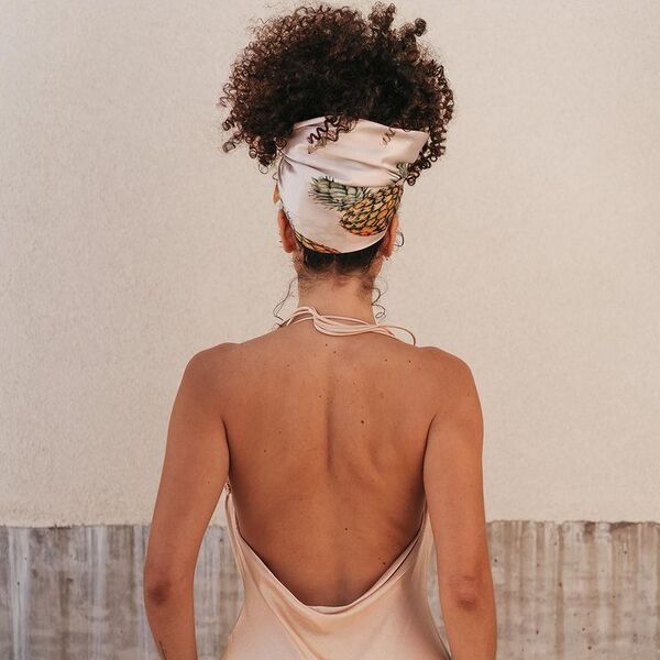 A woman wearing silk backless dress