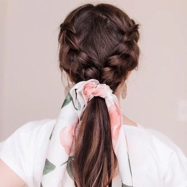 A cute floral scarf on woman's hair in white top