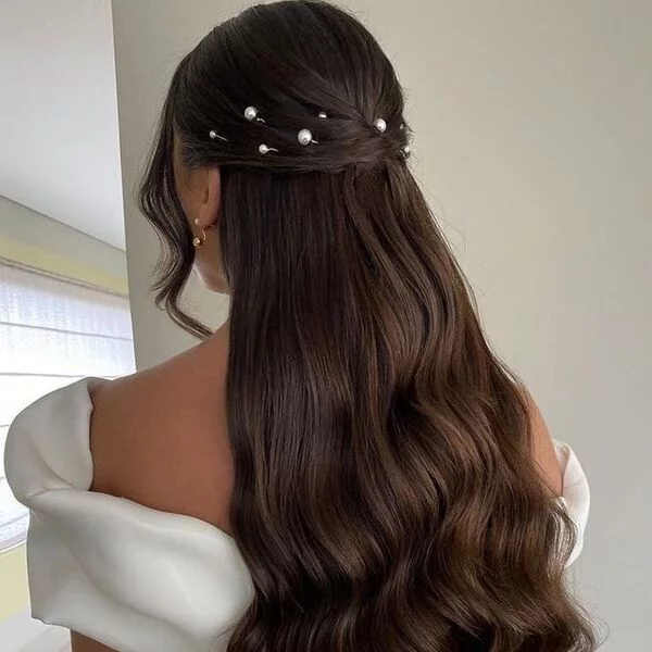 a woman wearing white dress had her hair styled to Elegant Half Up with Pearls and Bangs