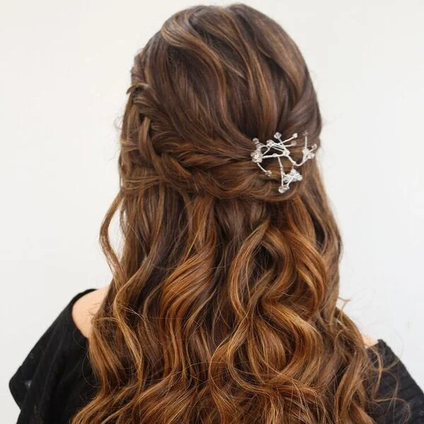 a woman wearing black off shoulder top had her hair styled to Half Up Braids with Warm Tones perfect for graduation