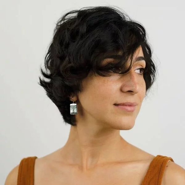 a woman wearing rust tank top had her hair styled to Messy Pixie with Fringe