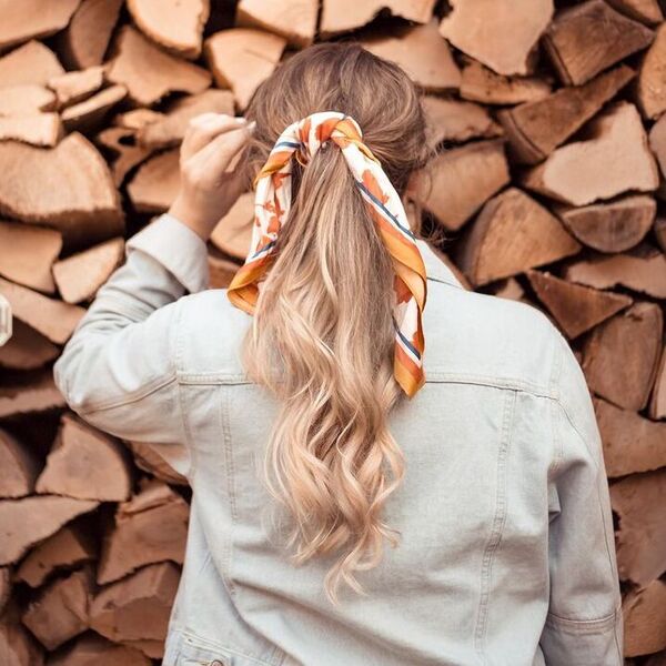 Messy Ponytail Scarf Tied - a woman wearing light denim jacket