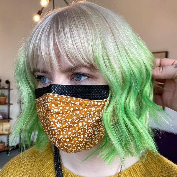 a woman wearing crochet mustard top with mask