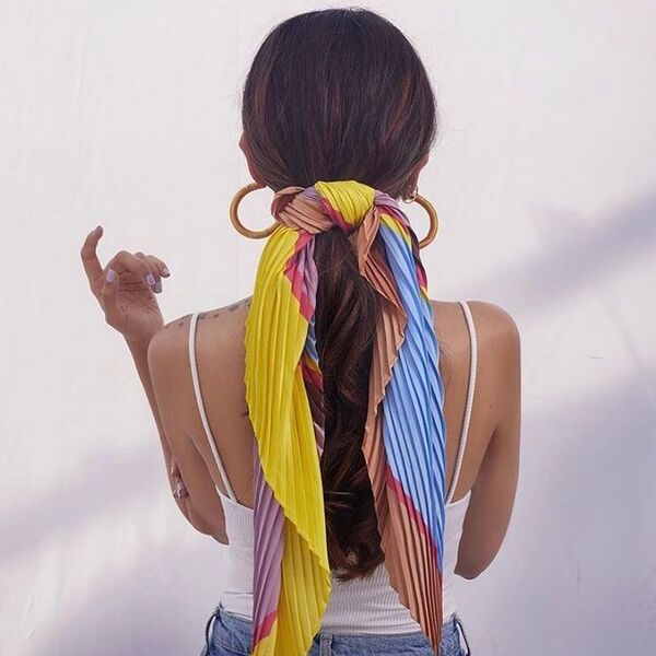 a woman wearing white basic top had her hair styled to Pleated Colorful Scarf Ponytail