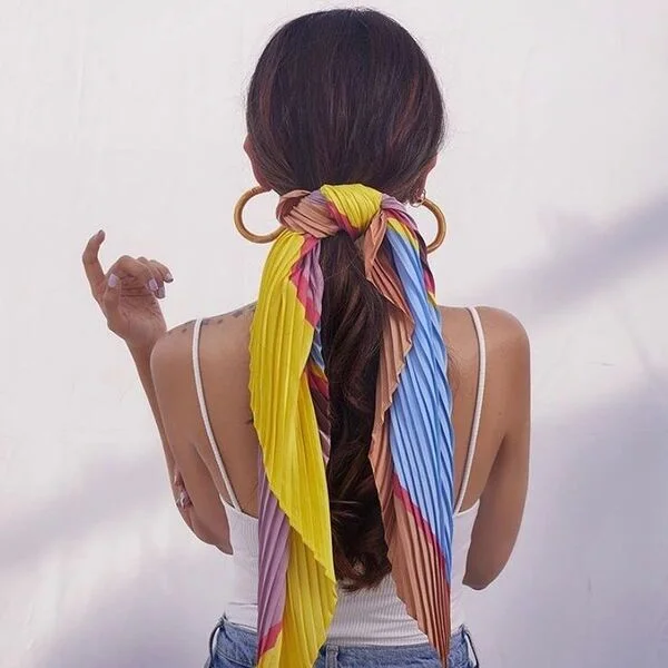 a woman wearing white basic top had her hair styled to Pleated Colorful Scarf Ponytail