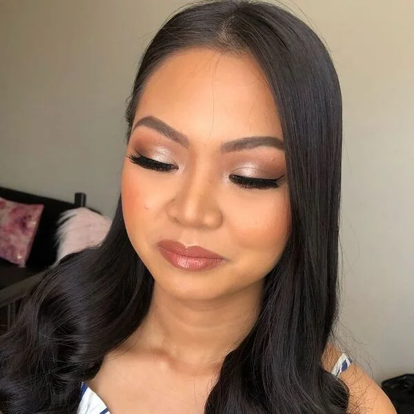 a woman wearing white dress had her hair stled to Simple and Easy Curled Ends for her graduation