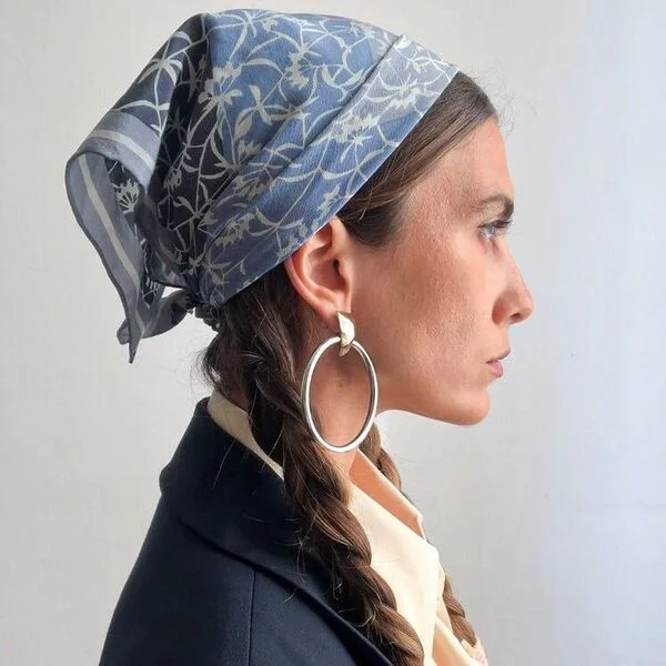 a woman wearing big loop earrings